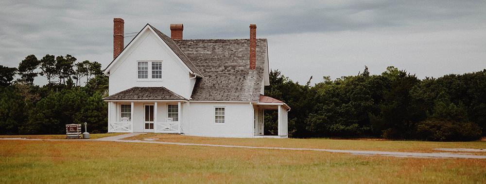 wooden house in a field