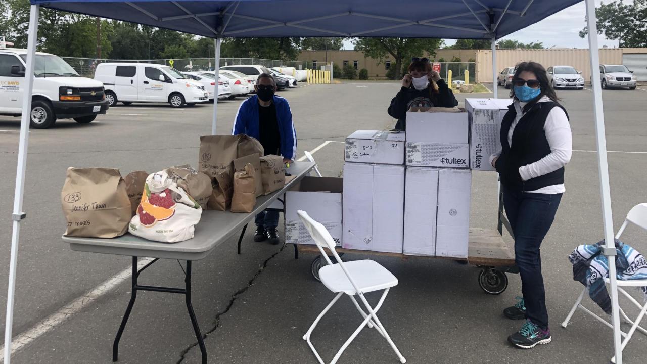 Johnny Flores, Lana Johnson and Amy Harris, of Repro Graphics, prepare to distribute face coverings at the Hopkins Services Complex Face Covering Distribution