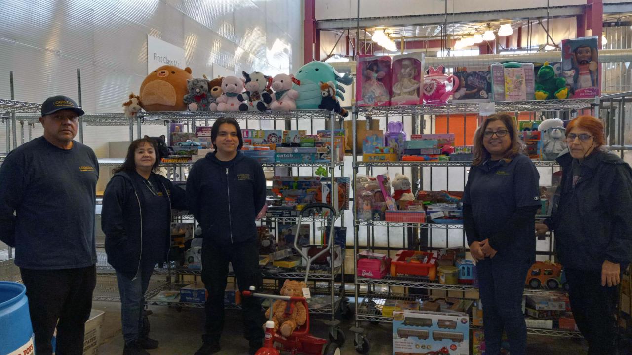Mail Services crew shows off Toy Drive collection.