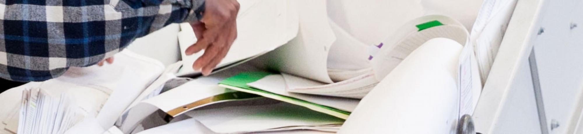 Employee shredding paper